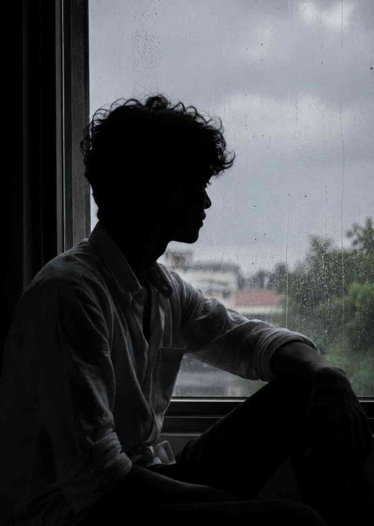 Cinematic rainy window silhouette portrait of a young man created with AI photo editing prompt